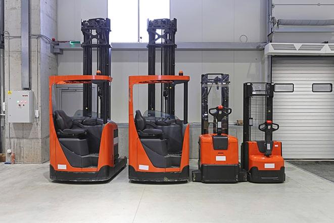 two red forklifts parked in a warehouse